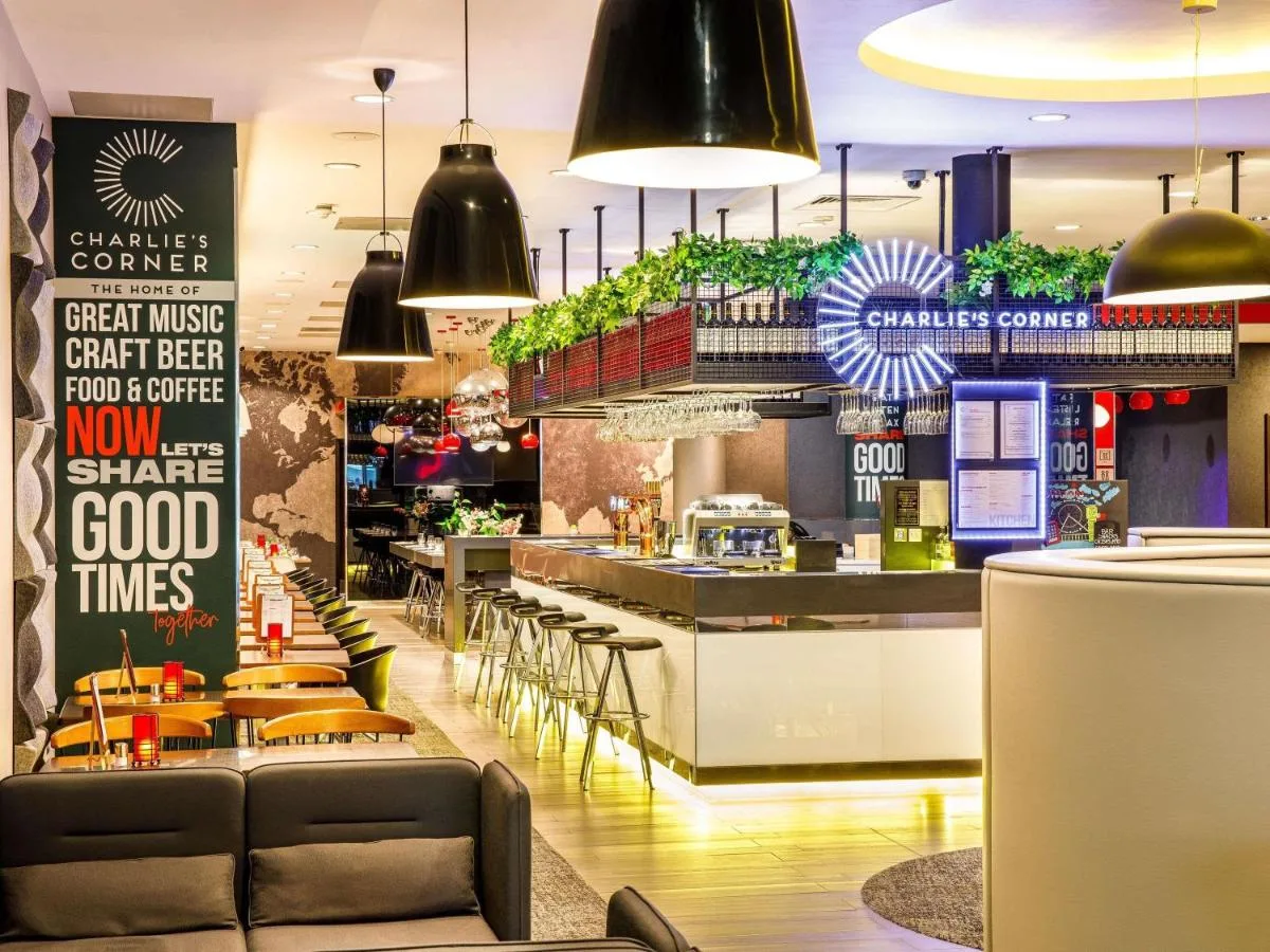 a restaurant with chairs and a counter and a bar at ibis London Blackfriars in London